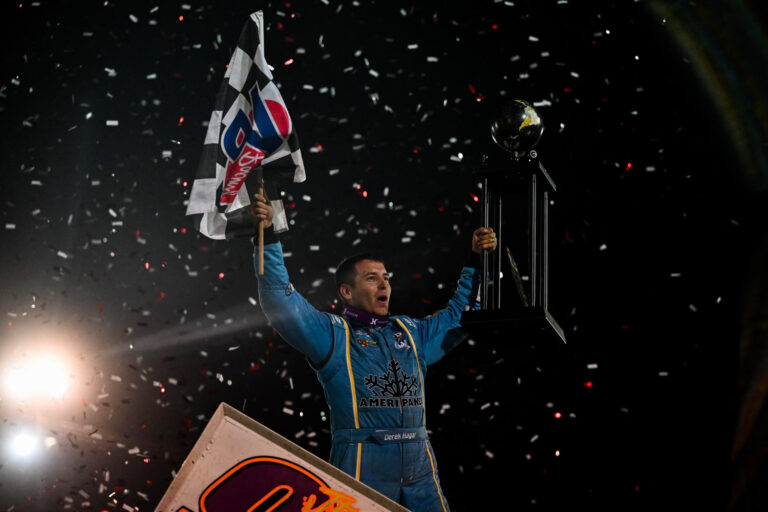 Derek Hagar celebrated after climbing from his car