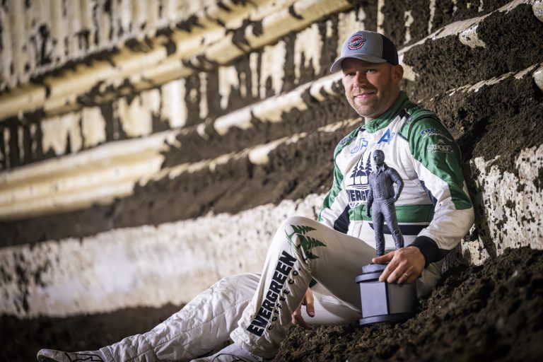 Bertman sitting on the cushion with trophy